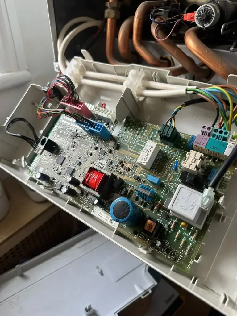 Boiler with front panel removed during a control board repair